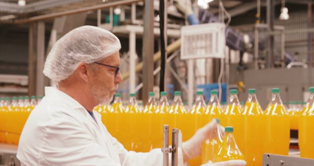 Factory Worker Checking Bottles on Juice Production Line - Download Free Stock Images Pikwizard.com