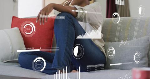 Woman sitting cross-legged on sofa with augmented reality analytics hud overlays for home lifestyle