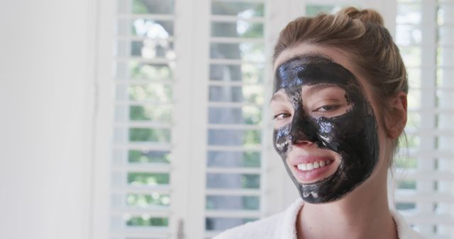 Smiling Woman with Charcoal Facial Mask at Home - Download Free Stock Images Pikwizard.com