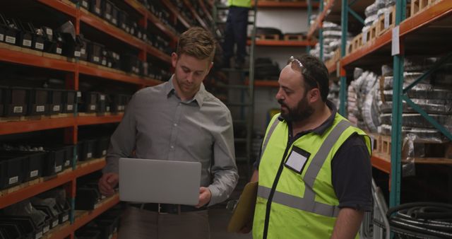 Warehouse Manager and Worker Reviewing Inventory on Laptop - Download Free Stock Images Pikwizard.com