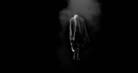 Mysterious Ghostly Figure in Smoke on Dark Background