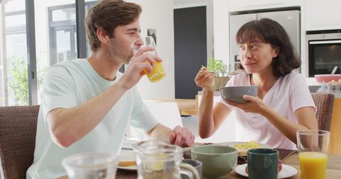 Diverse Couple Enjoying Breakfast Together in Modern Kitchen - Download Free Stock Images Pikwizard.com