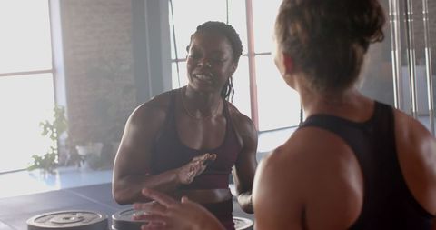 Women Discussing Fitness Goals in Gym Environment