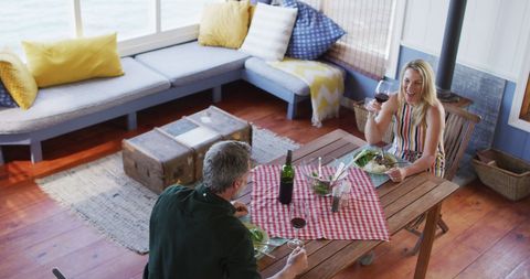 Relaxed Mature Couple Dining at Home with Joyful Atmosphere