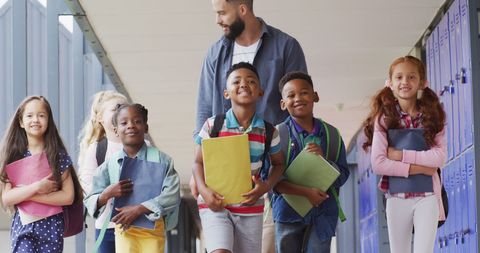 Teacher Leading Diverse Group of Happy Schoolchildren in School Hallway - Download Free Stock Images Pikwizard.com