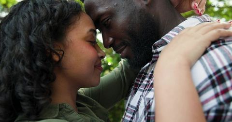 Romantic Couple Embracing in Park with Foreheads Touching