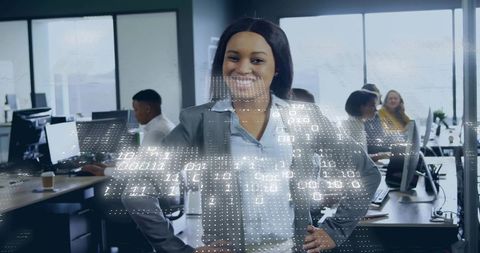 Confident businesswoman standing in modern office with digital binary data overlay