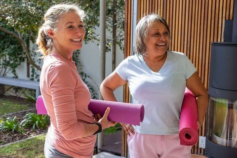Senior women enjoying outdoor yoga on a sunny patio