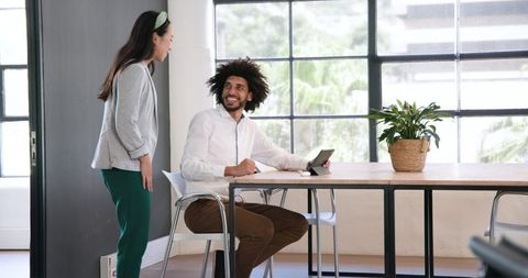 Business Professionals Discussing Project with Digital Tablet in Modern Office