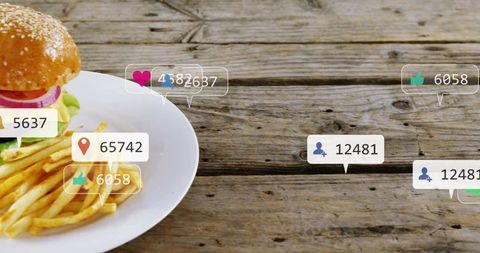 Burger and fries flatlay on rustic wooden table with social media engagement overlays