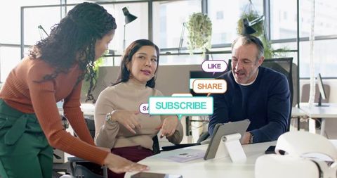 Creative team planning digital content with tablet and social media subscribe callouts