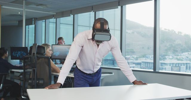 Businessman in VR headset leaning on office desk - Download Free Stock Images Pikwizard.com