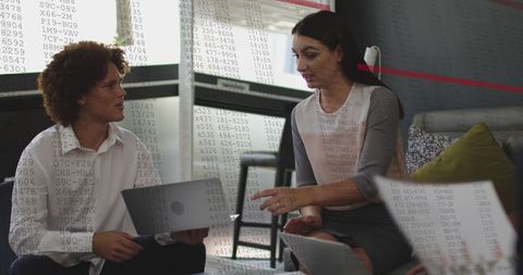 Diverse Business Team Analyzing Data on Laptops