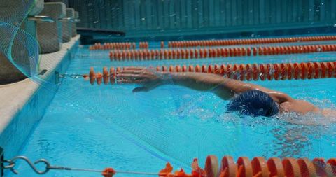 Professional swimmer executing front crawl in pool lane