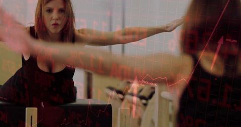 Woman stretching in fitness studio with stock market overlay