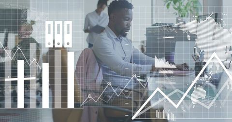 Business analyst working on laptop with analytics and financial charts overlay, teamwork concept