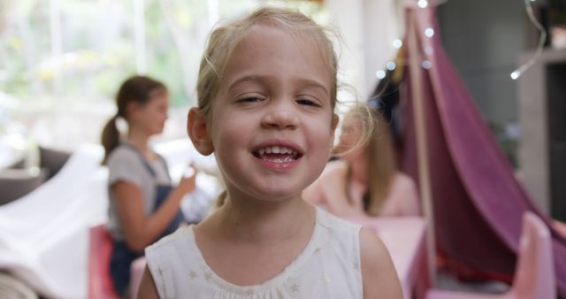 Smiling Young Girl with Friends in Playroom - Download Free Stock Images Pikwizard.com