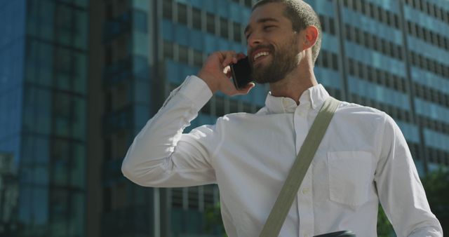 Confident Young Man Talking on Smartphone in Financial District - Download Free Stock Images Pikwizard.com