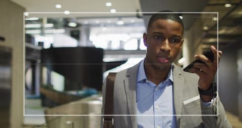 Professional Man in Modern Office Talking on Smartphone