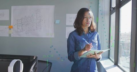 Creative designer using tablet with stylus in modern workspace