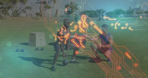 Trainer assisting client kettlebell deadlifting outdoors