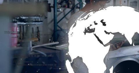 Automotive technician using tablet with digital globe overlay in industrial garage