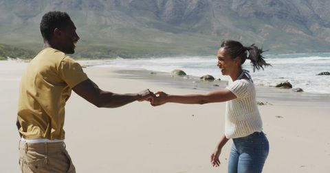 Joyful African American Couple Dancing on Scenic Beachfront