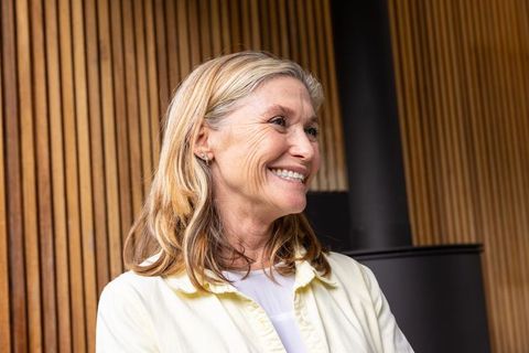 Senior Woman Enjoying Comfortable Atmosphere with Wood Stove