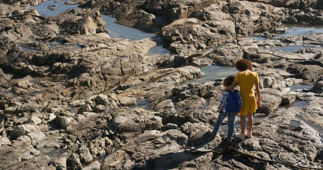 Mother and Son Standing on Rocky Beach in Sunny Weather - Download Free Stock Images Pikwizard.com