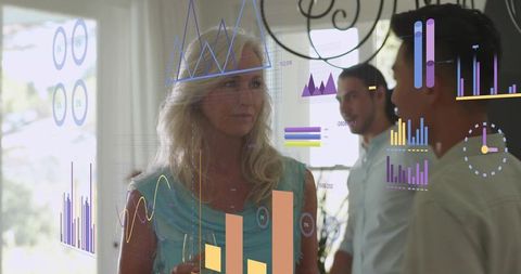 Senior woman holding wine glass listening at sunlit networking gathering with augmented analytics