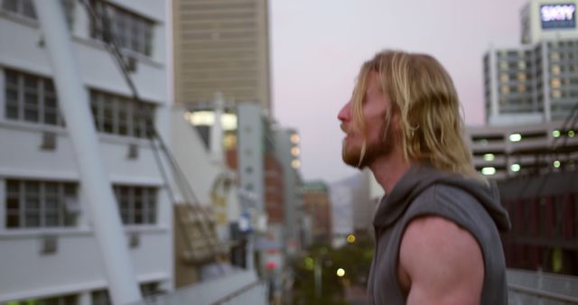 Man With Blond Hair Standing on Urban Bridge at Sunset - Download Free Stock Images Pikwizard.com