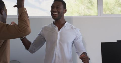 Men Celebrating Success in Modern Office Environment