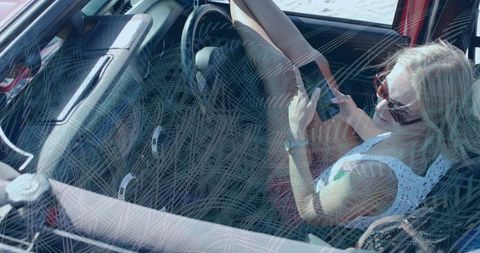 Relaxed Woman with Smartphone Inside Convertible on Sunny Day