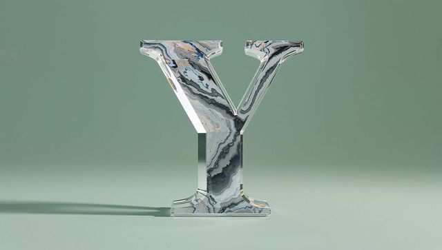 Reflective marbled y sculpture on muted green background