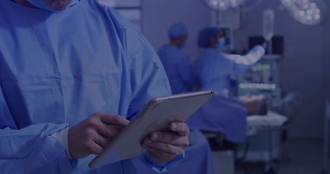 Surgeon Using Tablet in Modern Operating Room