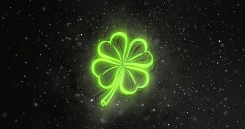 Neon green four-leaf clover emblem glowing with luminescent halo and floating particles