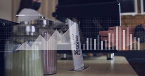 Displaying qr code on cafe table with laptop user, smartphone and data chart overlays