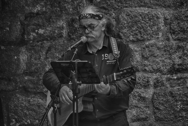 Elderly Musician Singing and Playing Guitar Outdoors in Black and White - Download Free Stock Images Pikwizard.com