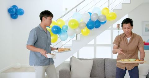 Father and Son Celebrating at Home Gathering