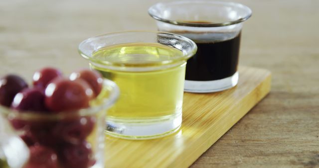 Close-up of Olive Oil, Vinegar, and Olives on Wooden Board - Download Free Stock Images Pikwizard.com