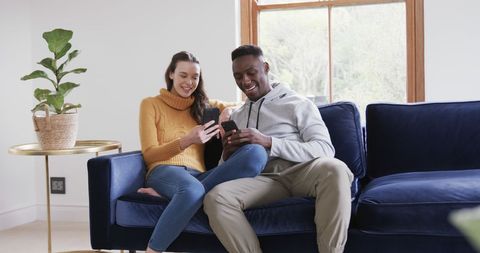 Happy Diverse Couple Shopping Online Using Smartphone