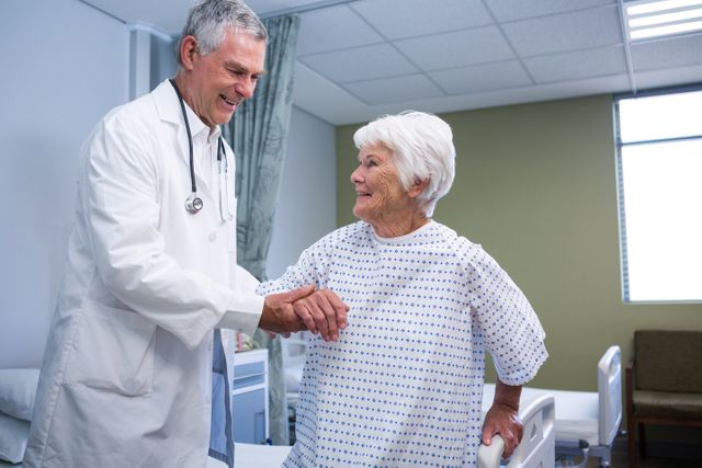 Doctor assisting senior patient in hospital ward. Ideal for use in healthcare, medical, and senior care-related content. Useful for illustrating patient care, medical assistance, and healthcare services in hospitals.