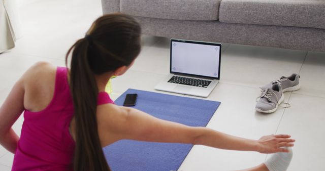 Woman Stretching at Home with Online Workout Video - Download Free Stock Images Pikwizard.com