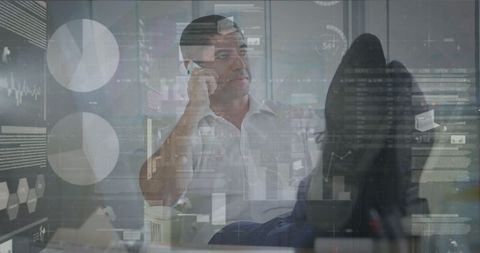 Businessman Analyzing Financial Data in Modern High-Tech Office