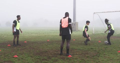 Diverse Soccer Practice on Foggy Field with Dynamic Dribbling