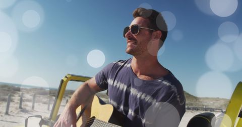 Musician Playing Guitar at Beach Learn to Relax Concept