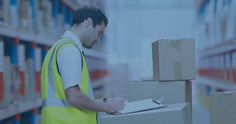 Warehouse worker checking inventory in high visibility vest