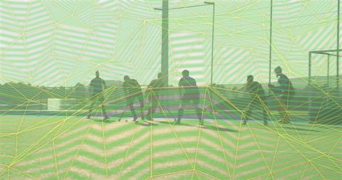 Backlit silhouette skate crew gathering at urban concrete skatepark near ramps and rails