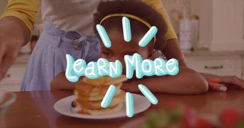 Mother and Daughter Enjoying Breakfast Pancakes Together at Kitchen Counter
