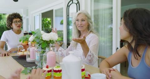 Joyful Friends Share Brunch at Sunlit Garden Table